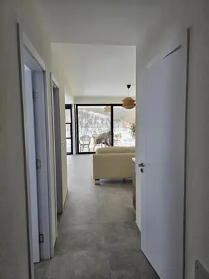 a hallway with a living room with a couch at Lake & Pool Paradise in Karaula