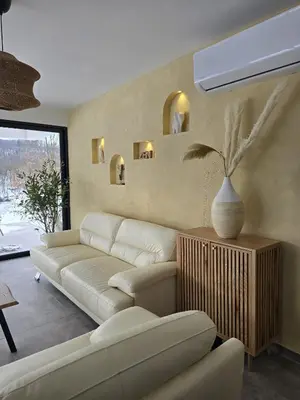 a living room with a couch and a vase at Lake & Pool Paradise in Karaula