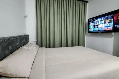a bedroom with a bed and a flat screen tv at Jacuzzi Sauna - Besplatan parking in Belgrade