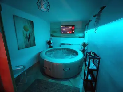 a large tub in a room with a television at Jacuzzi Sauna - Besplatan parking in Belgrade