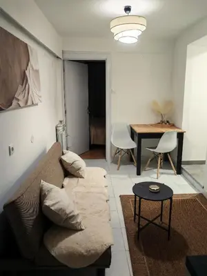 a living room with a couch and a table at Jacuzzi Sauna - Besplatan parking in Belgrade