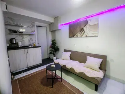 a living room with a couch and a table at Jacuzzi Sauna - Besplatan parking in Belgrade