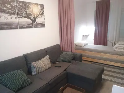 a living room with a couch and a bed at River Sava apartman in Belgrade