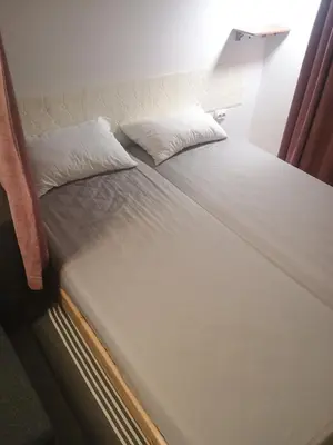 a bed with two pillows on it in a room at River Sava apartman in Belgrade