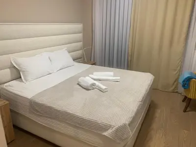 a bedroom with a bed with two towels on it at BW Exclusive apartment in Belgrade