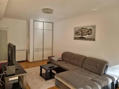 a living room with a couch and a television at Apartment MHarmony#Vracar in Belgrade