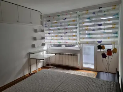 a bedroom with a window with a curtain with butterflies at Apartment MHarmony#Vracar in Belgrade