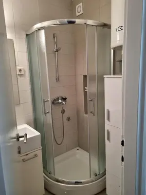 a shower with a glass door in a bathroom at Apartment MHarmony#Vracar in Belgrade