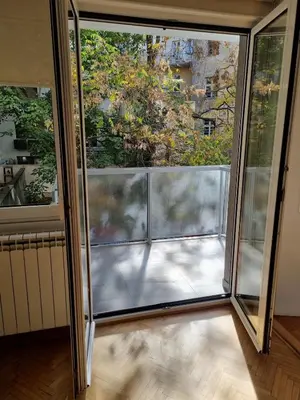 an open glass door with a view of a balcony at Apartment MHarmony#Vracar in Belgrade