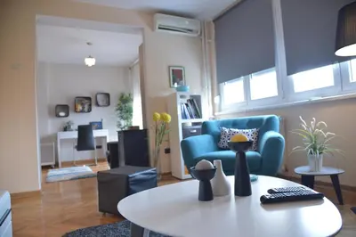 a living room with a blue couch and a table at Apartment Danica in Belgrade