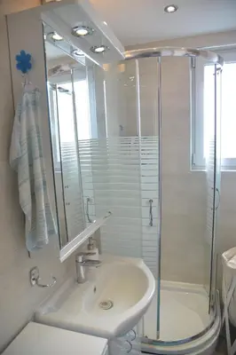 a bathroom with a glass shower and a sink at Apartment Danica in Belgrade