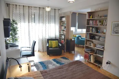 a living room with a bed and a living room with a couch at Apartment Danica in Belgrade