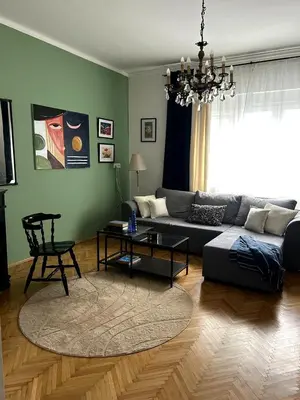 a living room with a couch and a table at Ollio Washington Apart in Belgrade