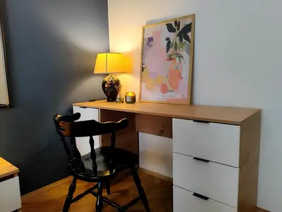 a desk with a chair and a lamp at Ollio Washington Apart in Belgrade