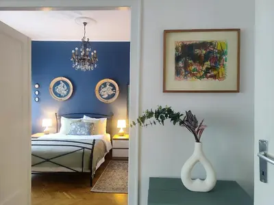 a bedroom with a bed and a vase on a table at Ollio Washington Apart in Belgrade