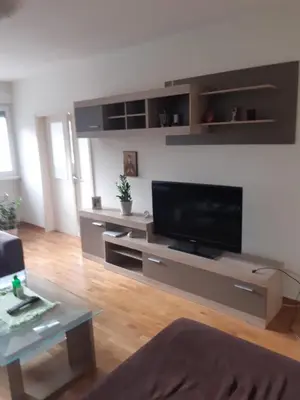 a living room with a large flat screen tv at Stan in Belgrade