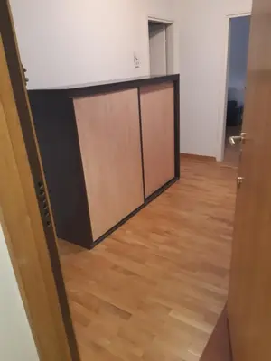 a door in a room with a wooden floor at Stan in Belgrade