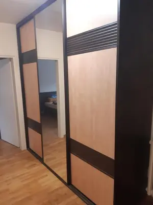 a mirrored door with a mirror in a room at Stan in Belgrade