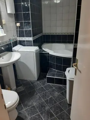 a bathroom with a tub and a toilet and a sink at Stan in Belgrade