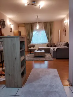a living room with a couch and a table at Apartman Lola in Lazarevac