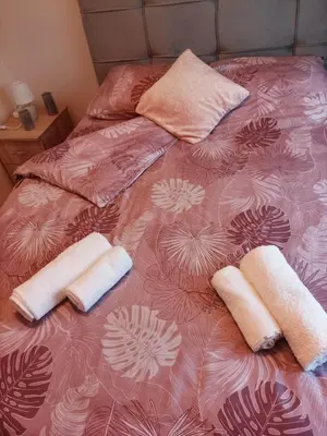 a bed with two towels and pillows on it at Apartman Lola in Lazarevac