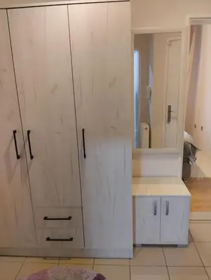 a white cabinet in a room with a mirror at Apartman Lola in Lazarevac