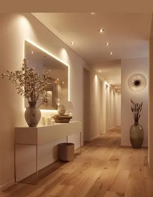 a hallway with a vase on a table and a mirror at Capo Zen