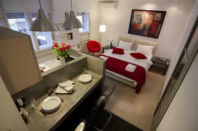 a bedroom with a bed and a bathroom with a mirror at Studio Apartment Picasso in Belgrade