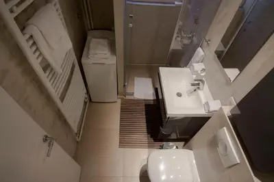 a small bathroom with a sink and a toilet at Studio Apartment Picasso in Belgrade