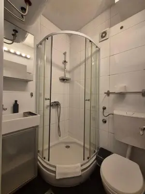 a bathroom with a shower with a toilet and a sink at Apartment Madera in Belgrade
