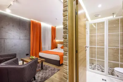 a hotel room with a bed and a bathroom at One Luxury Suites in Belgrade