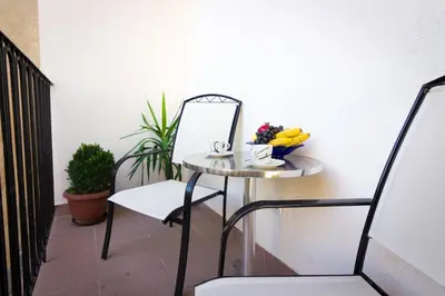 a small table with a mirror and a bowl of fruit at Apartment Drama Center in Belgrade
