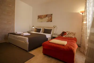 a hotel room with two beds and a couch at Apartment Drama Center in Belgrade