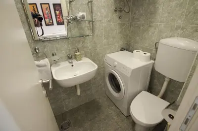 a small bathroom with a toilet and a sink at Apartment Drama Center in Belgrade
