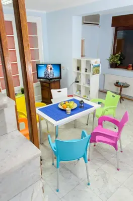 a living room with a table and chairs at Hostel White Town in Belgrade