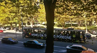 a trolley full of people riding in a city at Hostel Karavan Inn in Belgrade