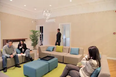 a group of people sitting in a living room at Hostel Karavan Inn in Belgrade