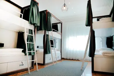 a bedroom with two bunk beds and a mirror at Hostel Karavan Inn in Belgrade