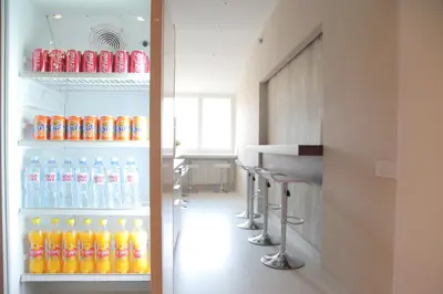 a refrigerator filled with lots of bottles of soda at Hostel Karavan Inn in Belgrade