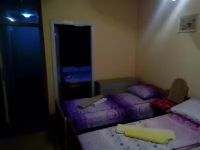 a bedroom with two beds and a mirror at Guest house Mirijevski Konak in Belgrade