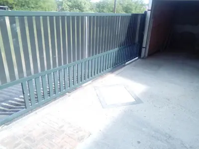 a metal fence with a door on a patio at Guest house Mirijevski Konak in Belgrade