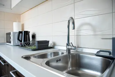 a stainless steel sink in a kitchen at Apartments Belvedere in Belgrade