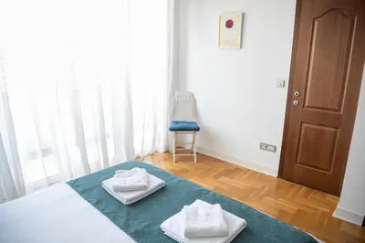 a bedroom with a bed with two towels on it at Apartments Belvedere in Belgrade