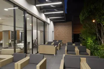 a waiting area with chairs and tables in a building at Hotel Orasac Garni in Belgrade