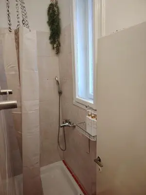 a bathroom with a shower with a sink and a tub at Apartment Alloga in Belgrade