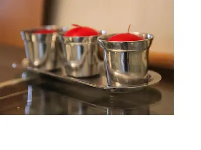 three metal cups with red apples in them on a tray at Apartment Alloga in Belgrade