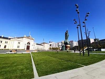 a park with a statue in front of a building at Apartment Alloga in Belgrade