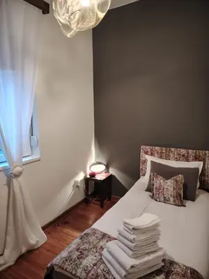 a bedroom with a bed with a bunch of towels on it at Apartment Alloga in Belgrade
