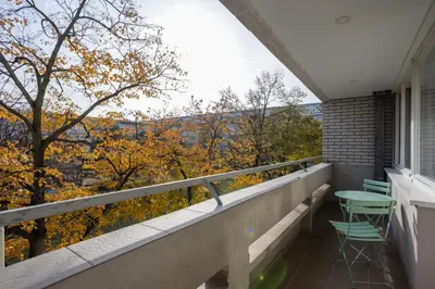 a balcony with two chairs and a table on it at Apartment Sara in Belgrade