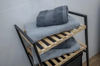 a pile of towels sitting on a shelf at Apartment Sara in Belgrade